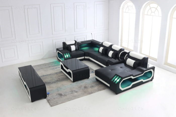 black u shaped leather couch with bluetooth speakers